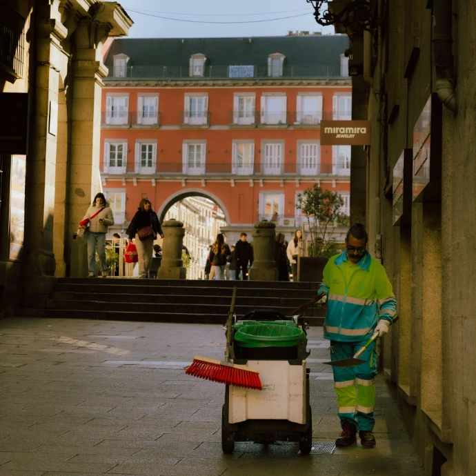 A person pushing a cart down a street